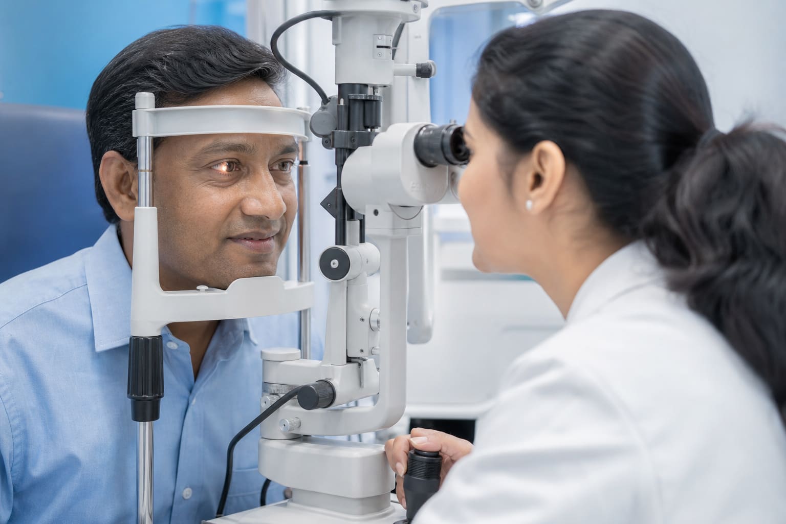 Ophthalmologist examining a patient's eyes with a slit lamp in a modern clinic